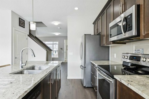 50 Fireside Circle, Cochrane, AB - Indoor Photo Showing Kitchen With Double Sink With Upgraded Kitchen