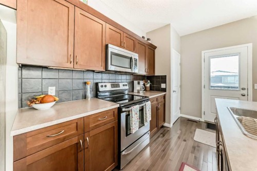 266 Fireside Place, Cochrane, AB - Indoor Photo Showing Kitchen With Double Sink