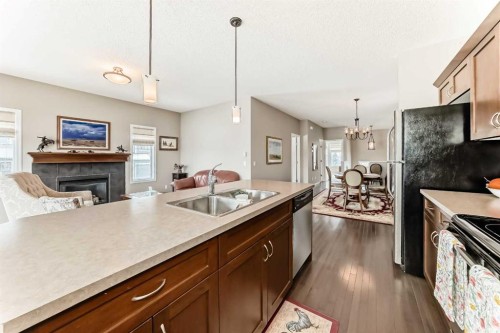 266 Fireside Place, Cochrane, AB - Indoor Photo Showing Kitchen With Fireplace With Double Sink