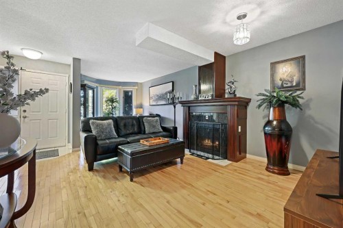 64 Abbeydale Villas Ne, Calgary, AB - Indoor Photo Showing Living Room With Fireplace