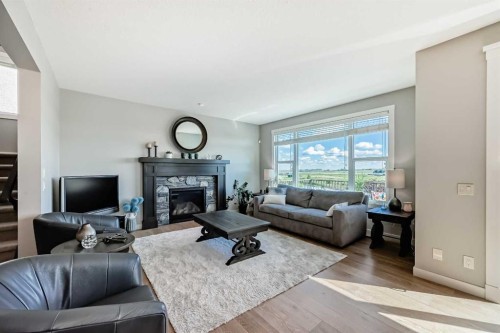 239 Stonemere Green, Chestermere, AB - Indoor Photo Showing Living Room With Fireplace
