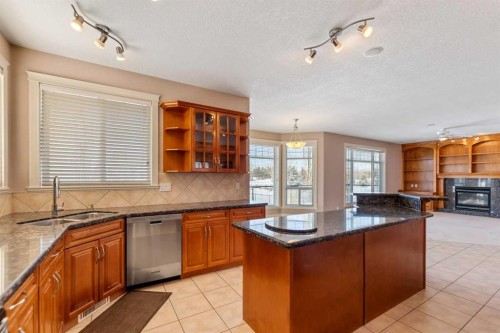 3 Lynx Meadows Drive Nw, Calgary, AB - Indoor Photo Showing Kitchen With Fireplace With Double Sink