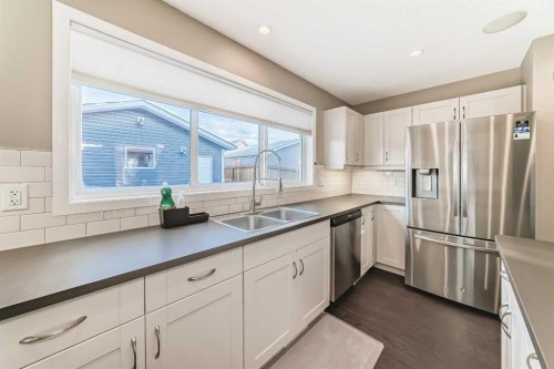 145 River Heights Crescent, Cochrane, AB - Indoor Photo Showing Kitchen With Stainless Steel Kitchen With Double Sink