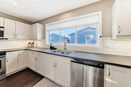 145 River Heights Crescent, Cochrane, AB - Indoor Photo Showing Kitchen With Stainless Steel Kitchen With Double Sink