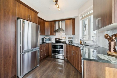 2302-15 Sunset Square, Cochrane, AB - Indoor Photo Showing Kitchen