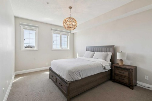 2302-15 Sunset Square, Cochrane, AB - Indoor Photo Showing Bedroom