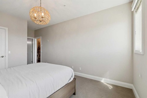 2302-15 Sunset Square, Cochrane, AB - Indoor Photo Showing Bedroom