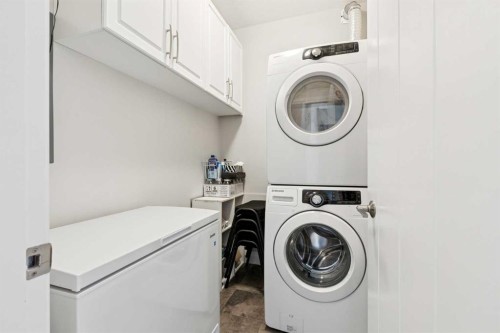 2302-15 Sunset Square, Cochrane, AB - Indoor Photo Showing Laundry Room