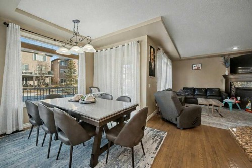 91 Panatella Close Nw, Calgary, AB - Indoor Photo Showing Other Room With Fireplace