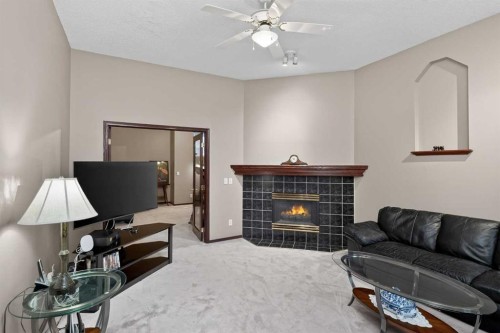 150 Somerset Close Sw, Calgary, AB - Indoor Photo Showing Living Room With Fireplace