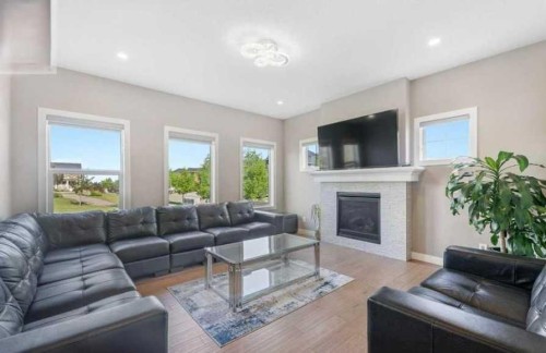 201 Aspenmere Way, Chestermere, AB - Indoor Photo Showing Living Room With Fireplace