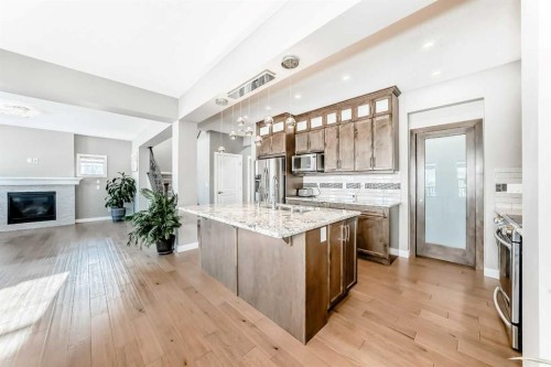 201 Aspenmere Way, Chestermere, AB - Indoor Photo Showing Kitchen With Fireplace With Stainless Steel Kitchen With Upgraded Kitchen