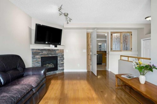 163 Eversyde Circle Sw, Calgary, AB - Indoor Photo Showing Living Room With Fireplace