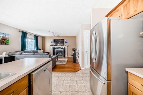 238 Bridleridge Way Sw, Calgary, AB - Indoor Photo Showing Kitchen With Fireplace