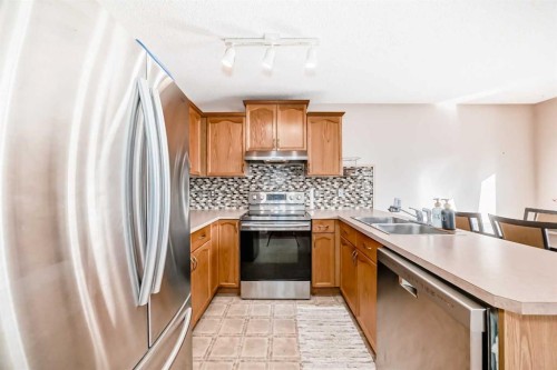 238 Bridleridge Way Sw, Calgary, AB - Indoor Photo Showing Kitchen With Double Sink