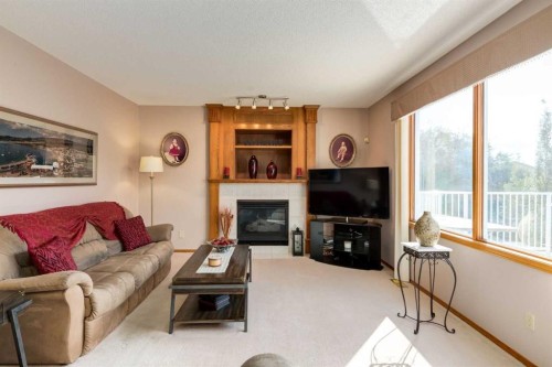 180 Edgevalley Circle Nw, Calgary, AB - Indoor Photo Showing Living Room With Fireplace