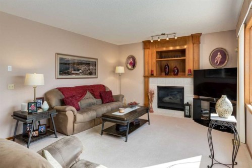 180 Edgevalley Circle Nw, Calgary, AB - Indoor Photo Showing Living Room With Fireplace
