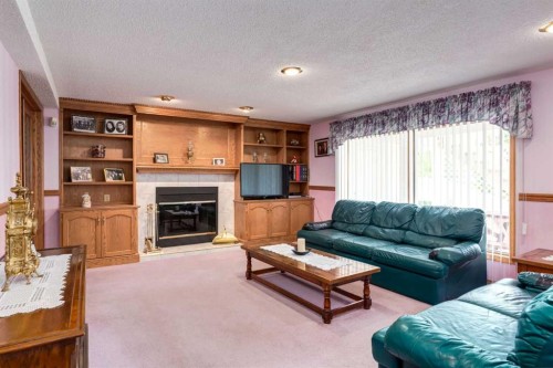 180 Edgevalley Circle Nw, Calgary, AB - Indoor Photo Showing Living Room With Fireplace