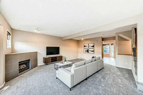 677 Regal Park Ne, Calgary, AB - Indoor Photo Showing Living Room With Fireplace