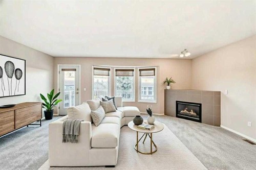 677 Regal Park Ne, Calgary, AB - Indoor Photo Showing Living Room With Fireplace