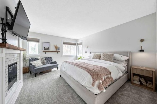 95 Cranleigh Gardens Se, Calgary, AB - Indoor Photo Showing Bedroom With Fireplace