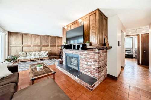 201-512 Cedar Crescent Sw, Calgary, AB - Indoor Photo Showing Other Room With Fireplace