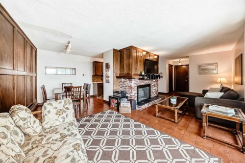 201-512 Cedar Crescent Sw, Calgary, AB - Indoor Photo Showing Living Room With Fireplace