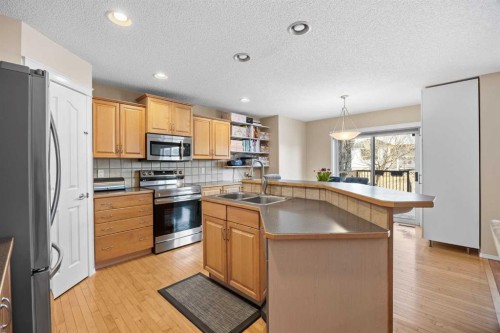 83 Cougarstone Way Sw, Calgary, AB - Indoor Photo Showing Kitchen With Double Sink
