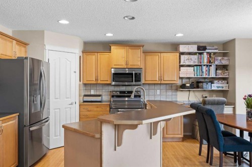 83 Cougarstone Way Sw, Calgary, AB - Indoor Photo Showing Kitchen With Double Sink