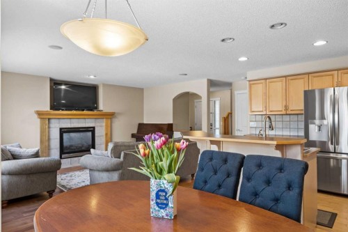83 Cougarstone Way Sw, Calgary, AB - Indoor Photo Showing Dining Room With Fireplace