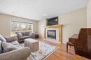 83 Cougarstone Way Sw, Calgary, AB  - Indoor Photo Showing Living Room With Fireplace 
