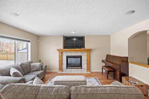 83 Cougarstone Way Sw, Calgary, AB - Indoor Photo Showing Living Room With Fireplace