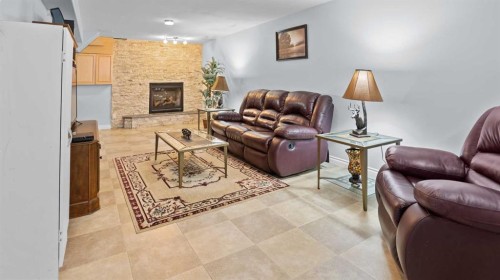 323 Mt Cornwall Circle Se, Calgary, AB - Indoor Photo Showing Living Room With Fireplace