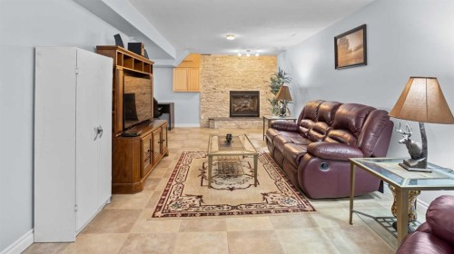 323 Mt Cornwall Circle Se, Calgary, AB - Indoor Photo Showing Other Room With Fireplace