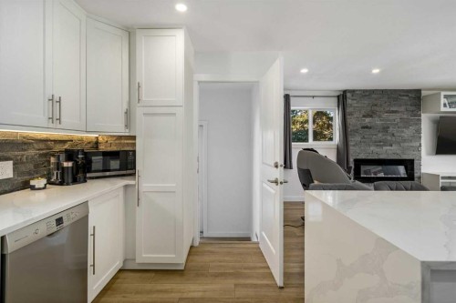 119 Silvercreek Close Nw, Calgary, AB - Indoor Photo Showing Kitchen With Fireplace