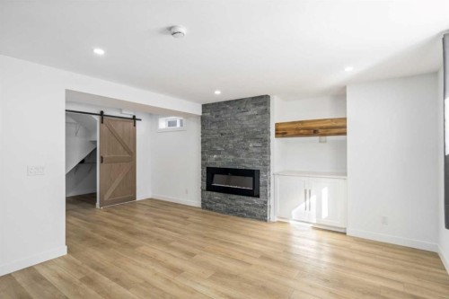 119 Silvercreek Close Nw, Calgary, AB - Indoor Photo Showing Living Room With Fireplace