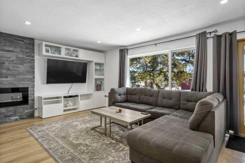 119 Silvercreek Close Nw, Calgary, AB - Indoor Photo Showing Living Room With Fireplace
