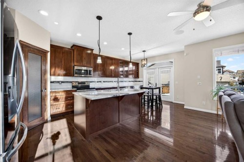 46 Heritage Landing, Cochrane, AB - Indoor Photo Showing Kitchen With Stainless Steel Kitchen With Double Sink With Upgraded Kitchen