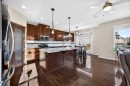 46 Heritage Landing, Cochrane, AB  - Indoor Photo Showing Kitchen With Stainless Steel Kitchen With Double Sink With Upgraded Kitchen 