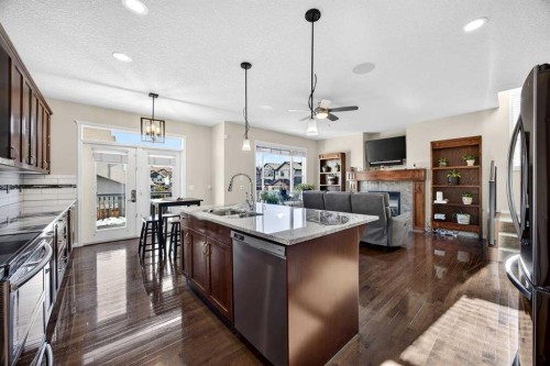 46 Heritage Landing, Cochrane, AB - Indoor Photo Showing Kitchen With Stainless Steel Kitchen With Upgraded Kitchen