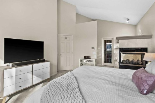 93 Cranwell Place Se, Calgary, AB - Indoor Photo Showing Bedroom With Fireplace