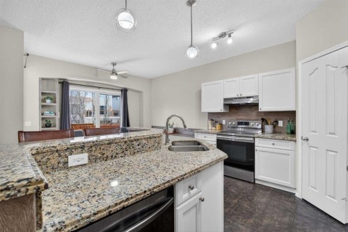 133 Cimarron Drive, Okotoks, AB - Indoor Photo Showing Kitchen With Double Sink