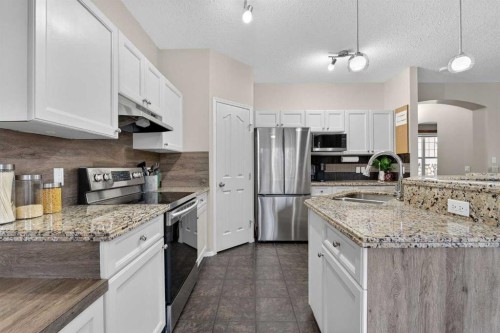 133 Cimarron Drive, Okotoks, AB - Indoor Photo Showing Kitchen With Double Sink With Upgraded Kitchen