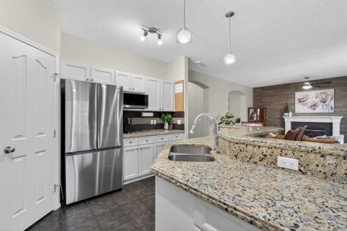 133 Cimarron Drive, Okotoks, AB - Indoor Photo Showing Kitchen With Double Sink With Upgraded Kitchen