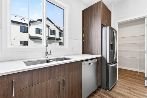 117-1750 Rangeview Drive Se, Calgary, AB - Indoor Photo Showing Kitchen With Double Sink