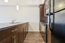 9312-101 Sunset Drive, Cochrane, AB  - Indoor Photo Showing Kitchen With Double Sink 