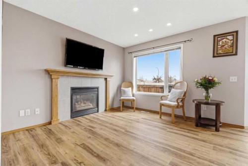 105 Douglas Ridge Circle Se, Calgary, AB - Indoor Photo Showing Living Room With Fireplace