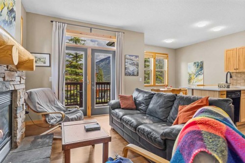 201-70 Dyrgas Gate, Canmore, AB - Indoor Photo Showing Living Room With Fireplace