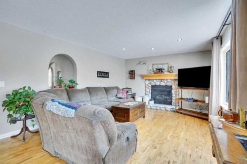 251 Lakeview Cove, Chestermere, AB - Indoor Photo Showing Living Room With Fireplace