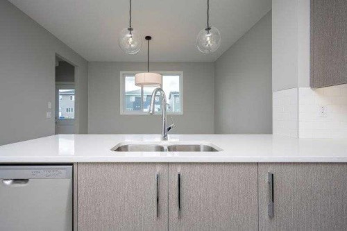 141 Dawson Wharf View, Chestermere, AB - Indoor Photo Showing Kitchen With Double Sink